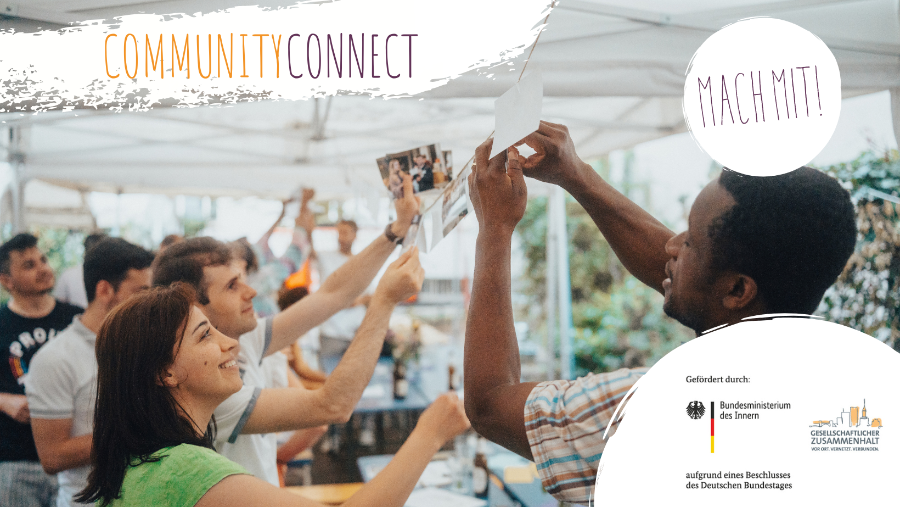 Mehrere Personen lächelnd mit Bildern in den Händen