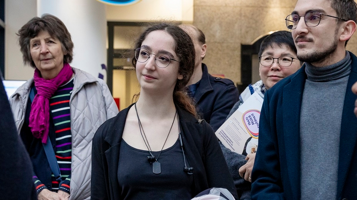 Mehrere Menschen stehen in einer Gruppe zusammen.